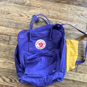 Purple fjalraven backpack with yellow water bottle holder